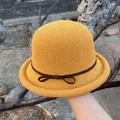 Detailed close-up of yellow crochet cloche hat with a bow and brown ribbon trim - M (56-58cm) / Yellow