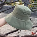 Detailed macro of olive green sun hat with ventilation eyelets and adjustable chin strap - Adjustable / Green