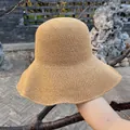 Close-up of fine crochet weave on a khaki wide-brim straw hat for summer sun protection - Large Brim Style / Khaki