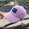 Close-up of vintage purple baseball cap featuring CIA embroidery and distressed brim details - Adjustable / Purple