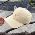 Close-up of cute cat embroidery on a beige cotton baseball cap with stitched brim - Adjustable / Khaki