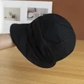 Detail showing the pleated canvas texture and wavy design of this black sun bucket hat - Adjustable / Black