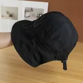 Detail of adjustable windproof strap and toggle on a black quick-dry sun bucket hat - Adjustable / Black