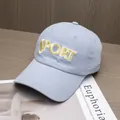 Detail of yellow SPORT embroidery on light blue cotton baseball cap with textured stitching - Adjustable / Blue