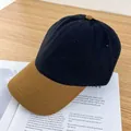Detail of color-block baseball cap with contrast brim on vintage magazine and wooden table - Adjustable / Black and Camel Brim