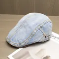 Detail of light blue denim beret with contrast yellow stitching and side buckle detail - Adjustable / Light Blue
