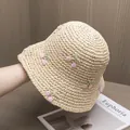 Close-up of beige straw sun hat featuring pink cherry embroidery and crochet texture - Adjustable / Beige Hat Pink Cherry