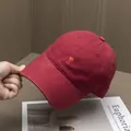 Detailed close-up of dark red cotton baseball cap featuring small heart embroidery - Adjustable / Burgundy