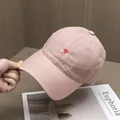 Close-up of soft pink twill cotton baseball cap with red heart embroidery on the front - Adjustable / Pink