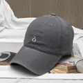 Detailed close-up of dark grey cotton baseball cap with white letter Ó embroidery - Adjustable / Dark Gray