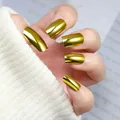 Macro view of gold mirror finish press-on nails on hand with white knit sweater - Box Packaging / Gold Yellow