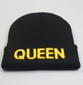 Detailed view of yellow QUEEN embroidery on a black knitted beanie with folded cuff - Adjustable / Black Gold QUEEN