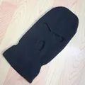 Detalle de un pasamontañas de punto negro con tres orificios y aberturas reforzadas - Negro