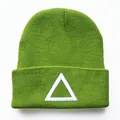 Makroansicht der grünen Strickmütze mit detaillierter weißer Dreiecksstickerei-Textur - Grasgrün Dreieck