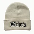 Close-up of black Bichota embroidery on a beige cuffed knit beanie for winter - Adjustable / Beige