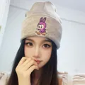 Beige ribbed knit beanie featuring a purple cartoon monster on a skateboard embroidery - Gray Skateboard