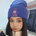 Royal blue knitted beanie featuring an embroidered cartoon rabbit on a skateboard - Denim Blue Skateboard