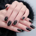 Glossy black short oval press-on nails with mirror finish on hands with black fur background - 32 Pieces/Pack / Mirror Black (YS2622-2)