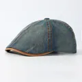 Vintage washed denim newsboy cap in blue with brown leather trim on white background - Adjustable / Grey Blue