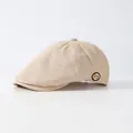 Beige newsboy cap with linen texture and small 'm' badge shown in a 45-degree front view - Adjustable / Beige