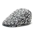Detail of black and white abstract textured fabric and metal buckle on newsboy cap - Adjustable / Black