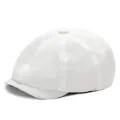 Detailed close-up of white cotton newsboy cap showing stitched panels and top button - White
