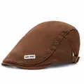 Detail view of brown cotton flat cap with GD-YST side label and metal strap buckle - Adjustable / Coffee