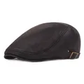 Detailed view of dark leather newsboy cap showing lychee texture and bronze buckle - Adjustable / Black