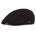 Detailed close-up of a black winter beret hat with a metallic logo plate and neat stitching - Adjustable / Black