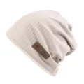 Beige ribbed knit beanie with leather label and metal fishbone pendant for winter warmth - One Size / Beige
