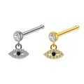 Macro view of gold and silver Evil Eye nose studs with blue stones and zircons - Evil Eye