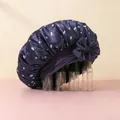 Detail of purple satin sleep bonnet featuring white cherry prints and a large silk bow decoration - Navy Blue