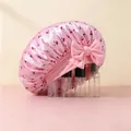 Detail of pink satin sleep cap with cherry print and large decorative bow on the side - Pink