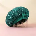 Detailed close-up of dark green satin sleep cap with cherry print and side bow detail - Aqua Blue