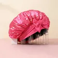 Detail of pink satin sleep cap with cherry print and large decorative side bow - Rose Red