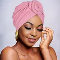 Detail of pink knitted turban hat featuring a decorative floral knot and elegant texture - Dusty Pink