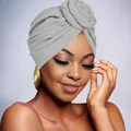 Detail of grey knit turban hat featuring a decorative layered floral knot design - Light Gray