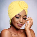 Macro shot of yellow bohemian turban hat with large spiral flower knot detail on model - Yellow