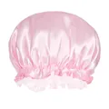 Close-up of pink satin hair bonnet with elastic band and decorative ruffle details - Pink