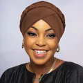 Detail view of brown braided turban headwrap showing textured cross-weave and fabric layers - Coffee
