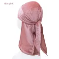 Detail view of skin pink velvet durag for children with long tail and smooth texture - One Size / Dusty Pink