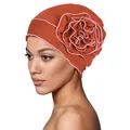 Detail of soft turban cap with large handmade layered flower and pink stitched edges - One Size / Brick Red