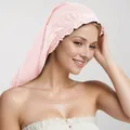 Pale pink satin sleep bonnet with elastic band shown on a model for hair protection - Pink