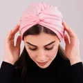 Close-up of a light pink knotted turban hat for women in soft stretch jersey fabric - One Size / Pink