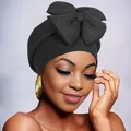 Detail of elegant black turban featuring a large 3D bow design on high-quality elastic fabric - Black
