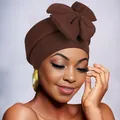 Close-up of brown bow turban hat showing ribbed fabric texture and large bow detail - Coffee