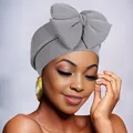 Close-up of dark grey turban with large bow decoration and textured elastic knit fabric - Gray