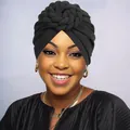 Close-up of black twisted turban hat with large layered floral knot decoration - One Size / Black