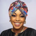 Close-up of vibrant African style paisley pattern print on a soft bohemian turban hat - Red