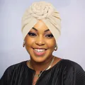 Close-up of beige knit turban with intricate handmade 3D floral weave decoration - One Size / Off White